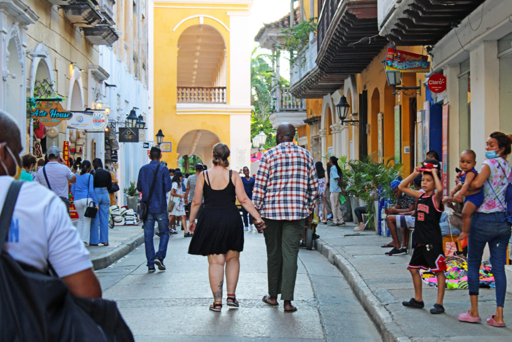 The Cartagena One-week Itinerary starts in the Historic Center Centre. Photo of couple holding hands and walking through the city centre.